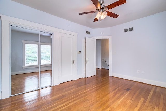 unfurnished bedroom with light wood finished floors, visible vents, a closet, and baseboards