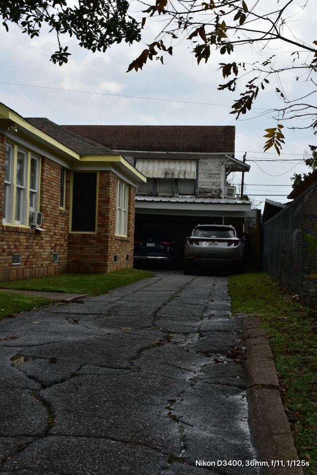 view of home's exterior featuring brick siding, fence, cooling unit, crawl space, and driveway