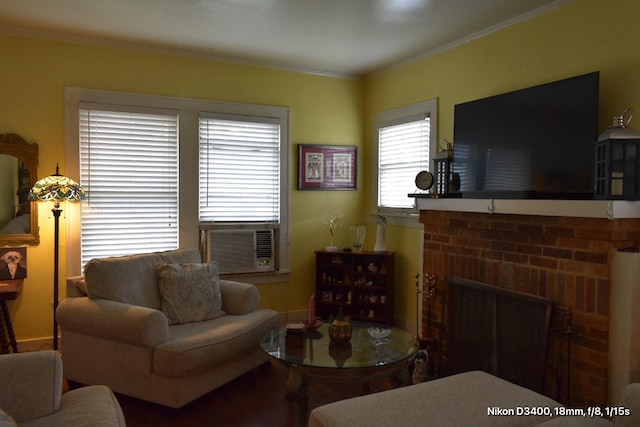 living room with cooling unit, ornamental molding, and a fireplace