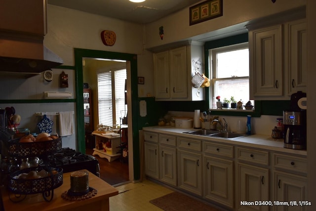 kitchen featuring light countertops, light floors, and a sink