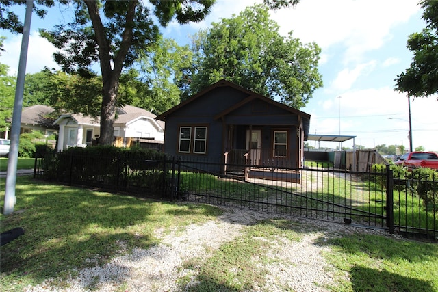 bungalow-style house with a fenced front yard and a front yard