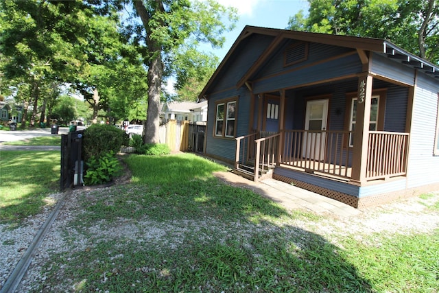 exterior space featuring covered porch and a front lawn