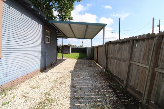 view of yard with a storage unit, an outdoor structure, and a fenced backyard