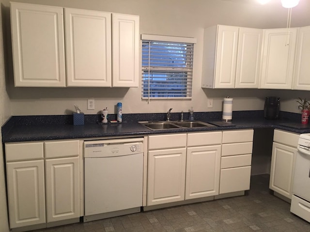 kitchen featuring a sink, dark countertops, dishwasher, and white cabinetry