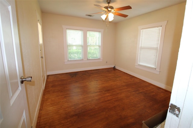 spare room with visible vents, baseboards, wood finished floors, and a ceiling fan