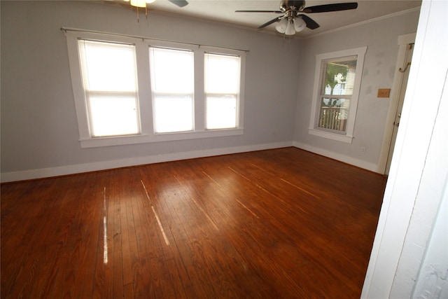 empty room featuring hardwood / wood-style flooring, a ceiling fan, baseboards, and ornamental molding