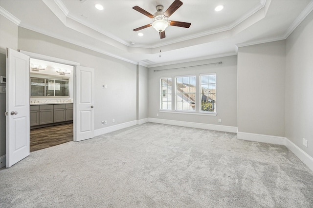 unfurnished bedroom featuring baseboards, ornamental molding, carpet flooring, recessed lighting, and a raised ceiling