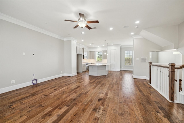 unfurnished living room with visible vents, crown molding, baseboards, recessed lighting, and dark wood-style floors