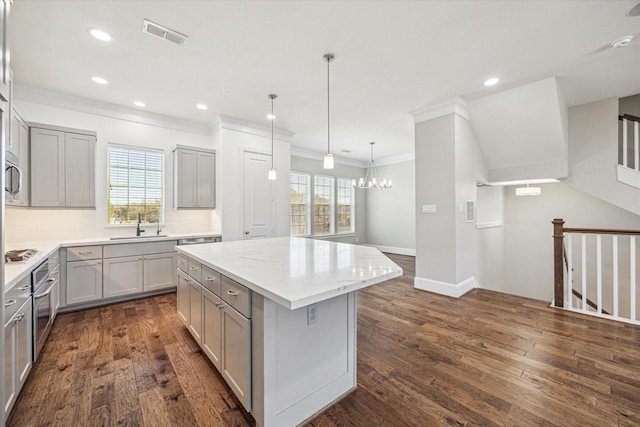 kitchen featuring visible vents, appliances with stainless steel finishes, gray cabinets, and a healthy amount of sunlight