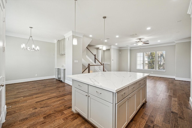 kitchen featuring dark wood finished floors, open floor plan, and ornamental molding