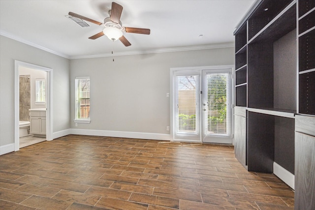 unfurnished room with ornamental molding, baseboards, visible vents, and wood finish floors