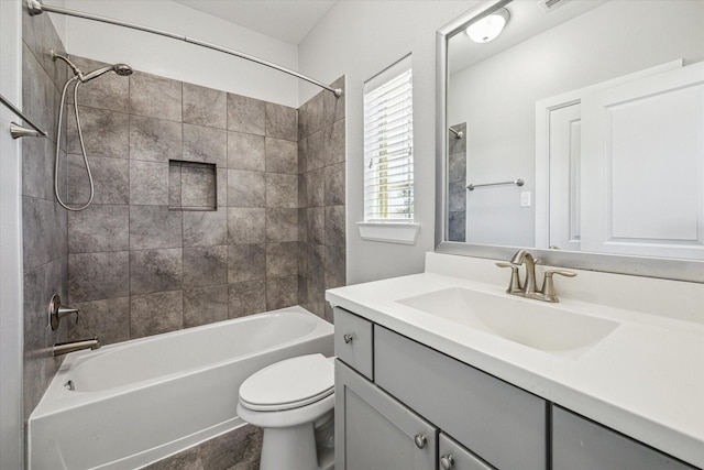 bathroom featuring vanity, toilet, visible vents, and shower / bathtub combination