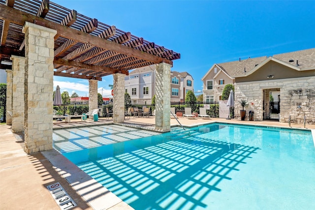 pool featuring a patio area, a pergola, and fence