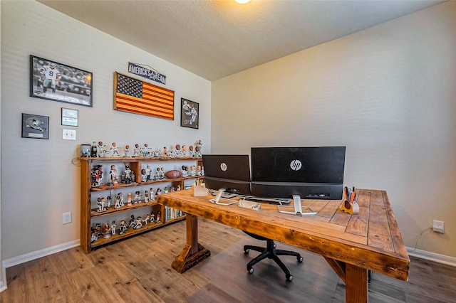 office featuring baseboards and wood finished floors