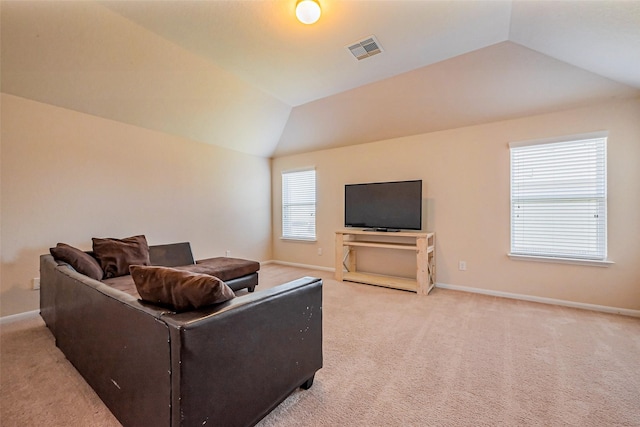 living room with light carpet, visible vents, baseboards, and lofted ceiling