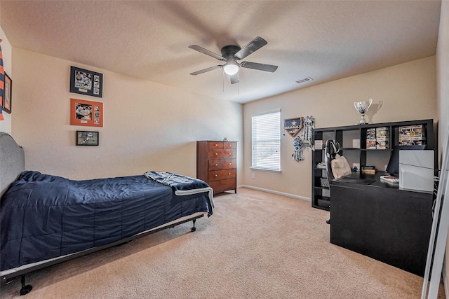 bedroom with visible vents, a ceiling fan, a textured ceiling, carpet flooring, and baseboards