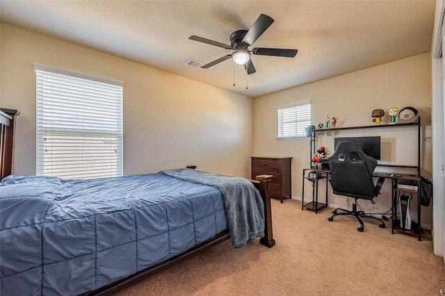 bedroom featuring light carpet, visible vents, baseboards, and a ceiling fan