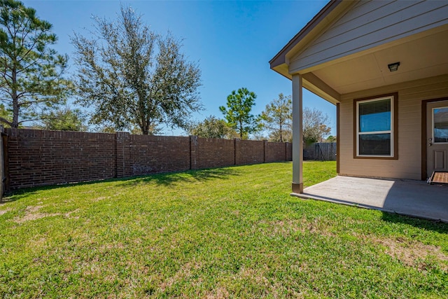 view of yard with a patio area and a fenced backyard