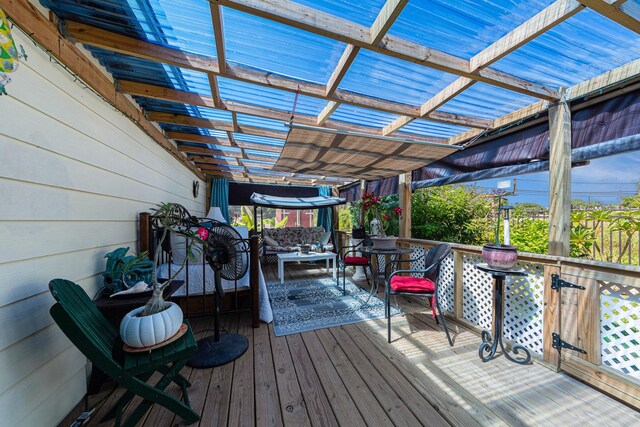 wooden deck with an outdoor living space and a pergola