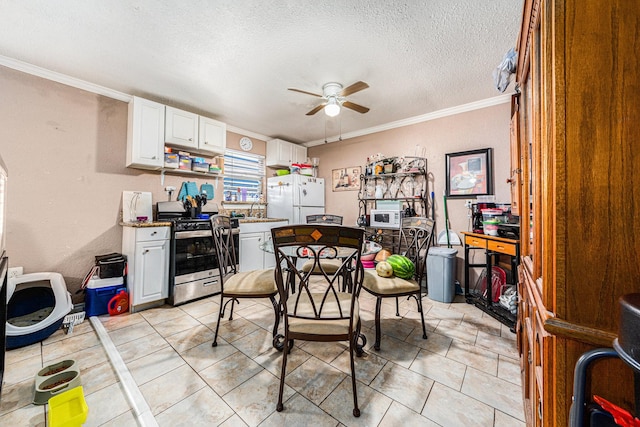 kitchen featuring a ceiling fan, a textured ceiling, white cabinetry, white appliances, and crown molding