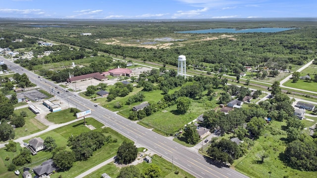 birds eye view of property featuring a water view and a view of trees