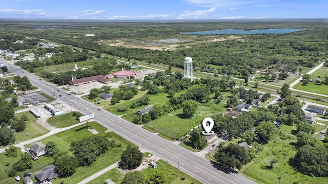 birds eye view of property featuring a view of trees and a water view