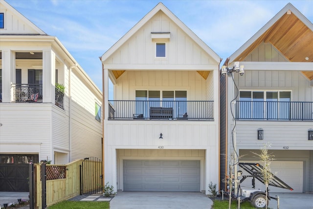 view of front facade featuring board and batten siding, driveway, a garage, and a gate