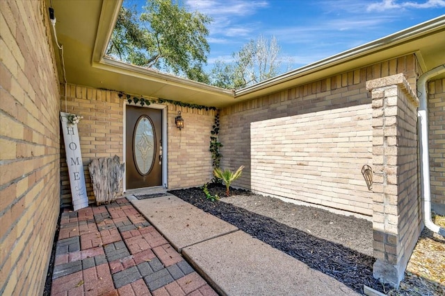 entrance to property featuring brick siding