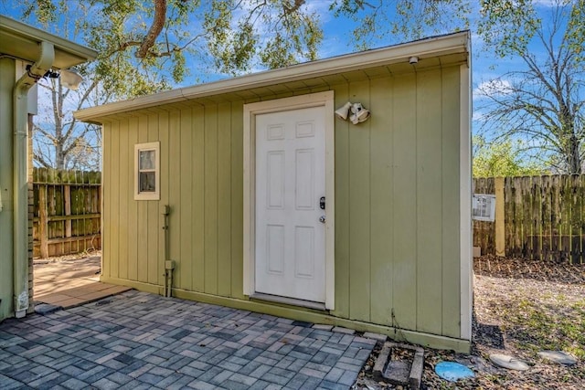 view of shed featuring fence