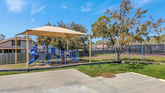 community playground with a fenced backyard and a lawn