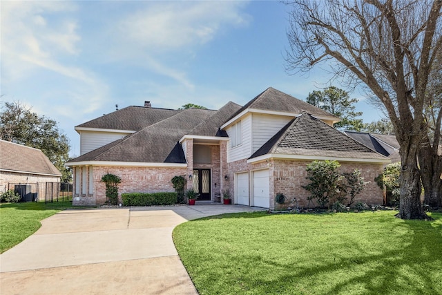 traditional-style house with brick siding, a garage, concrete driveway, and a front yard