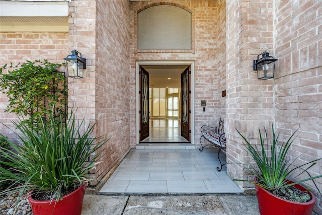 view of exterior entry with brick siding