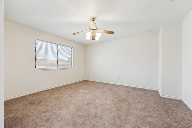 empty room featuring a ceiling fan, baseboards, and carpet floors