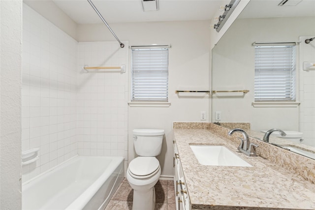 bathroom with vanity, washtub / shower combination, visible vents, tile patterned floors, and toilet