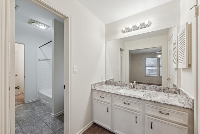 bathroom featuring visible vents, baseboards, washtub / shower combination, vanity, and a ceiling fan