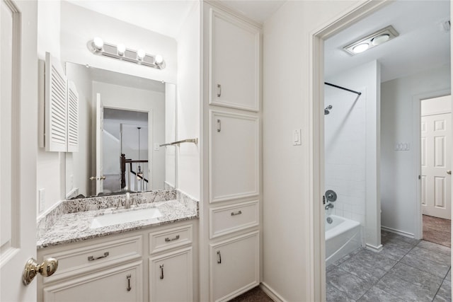 bathroom with baseboards, bathing tub / shower combination, and vanity