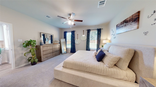 carpeted bedroom featuring visible vents, baseboards, and a ceiling fan