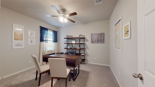 carpeted office space featuring visible vents, baseboards, and ceiling fan