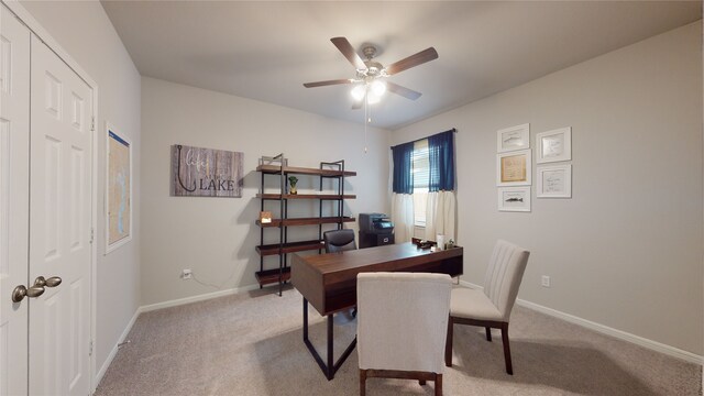 office area with baseboards, light colored carpet, and ceiling fan