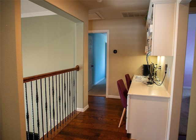 corridor featuring dark wood finished floors, visible vents, attic access, and baseboards