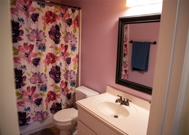 bathroom featuring vanity, toilet, and shower / tub combo with curtain