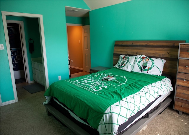 carpeted bedroom featuring baseboards and vaulted ceiling