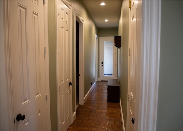 hall with recessed lighting, dark wood-style floors, and baseboards