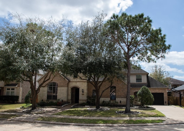 view of front of house featuring concrete driveway, a garage, brick siding, and a shingled roof