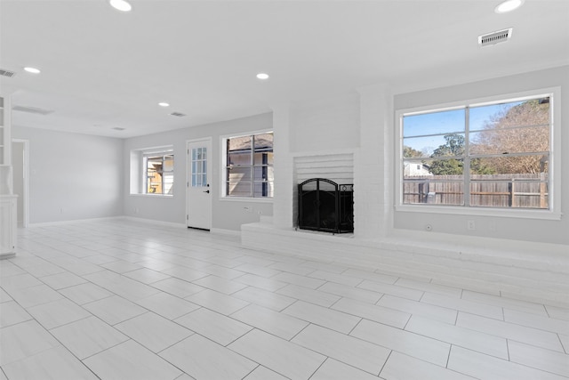 unfurnished living room featuring recessed lighting, a fireplace, and visible vents