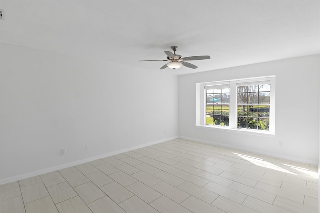 unfurnished room featuring visible vents, baseboards, and ceiling fan