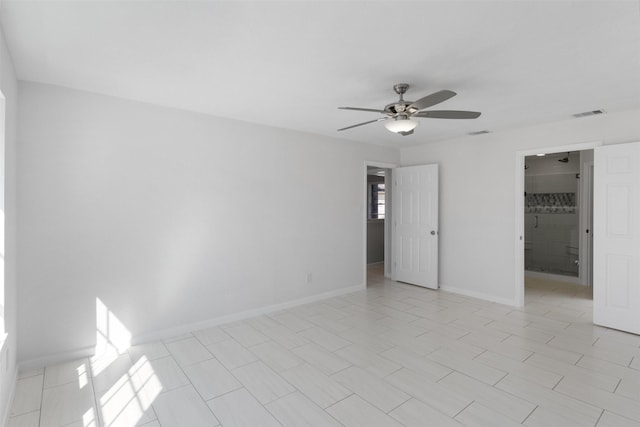 empty room with visible vents, baseboards, and ceiling fan