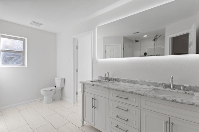 bathroom with double vanity, toilet, a shower with shower door, and a sink