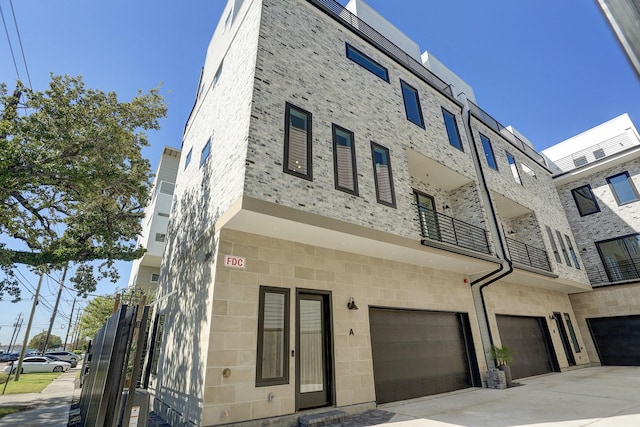 view of property with an attached garage and driveway