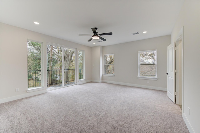 unfurnished room with recessed lighting, visible vents, light colored carpet, and baseboards